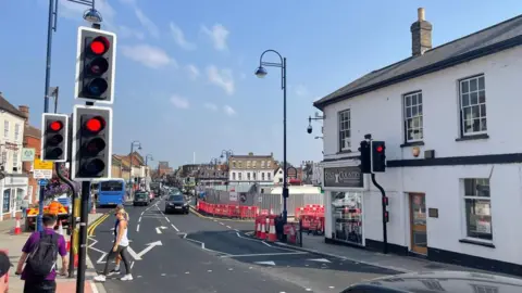 Ben Schofield/BBC A general street view of St Neots, showing people crossing a road