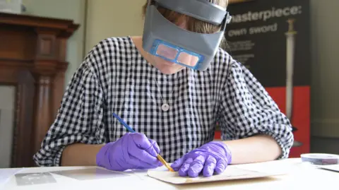 National Trust A specialist conservator helping to preserve the original 1939 photographs