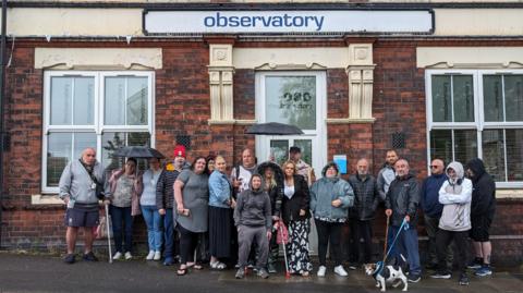 People standing outside the Observatory building in Stoke-on-Trent