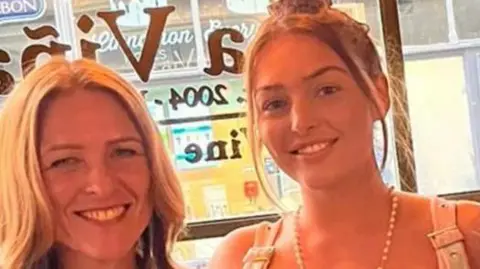 handout Group picture showing Gail Smith and daughter Elinor O'Brien smiling in a cafe