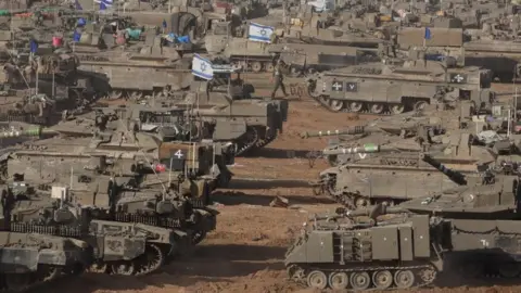 EPA Israeli tanks and armoured vehicles seen near the Gaza fence