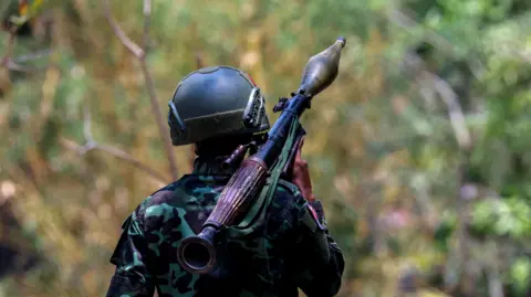 Reuters A soldier from the Karen National Liberation Army (KNLA) carries an RPG launcher at a Myanmar military base at Thingyan Nyi Naung village on the outskirts of Myawaddy, the Thailand-Myanmar border townr, April 15, 2024.