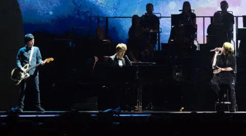 Getty Images Johnny Marr on stage at the Brit Awards with Billie Eilish and her brother Finneas