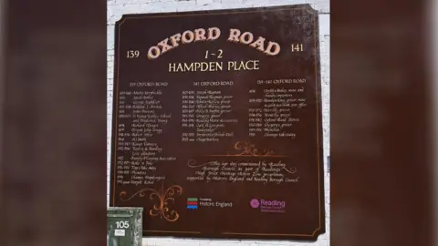 LDRS A dark red sign painted on to a brick wall which lists a number of former businesses with the dates that they operated out of 139 - 141 Oxford Road.