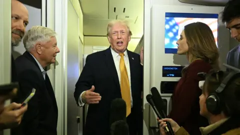 US President Trump aboard Air Force One on 4 January.