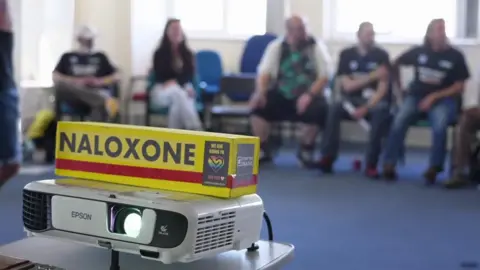A box of Naloxone on a projector 