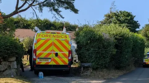 A police van in the driveway of Ann Widdecombe's home on Dartmoor