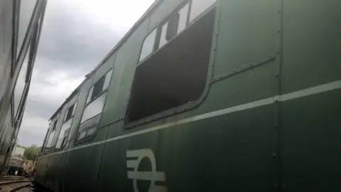 Downpatrick and County Down Railway A green carriage with the window put through