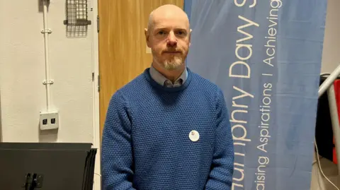 Matt Street at Humphrey Davy School wearing a blue jumper. 