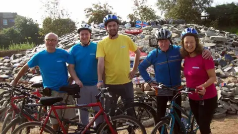 summonedbyfells The No Borders Bike Team at the cairn in 2014