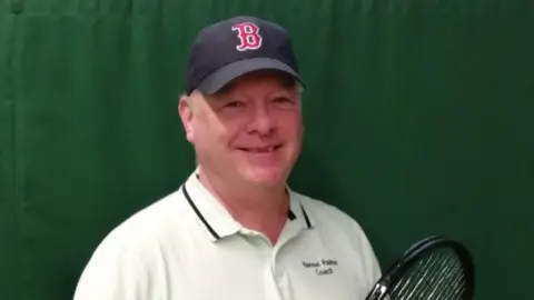 Handout A photo of Hansel Palmer, a friend of tennis player Dan Evans, smiling and holding a tennis racket