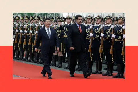 Getty Images Nicolas Maduro (R) walks with Chinese President Xi Jinping (L) in Beijing, China
