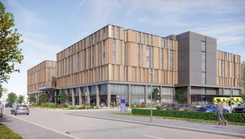 Kettering General Hospital Four-storey wood and metal-faced building with long and thin windows, with road and walkway to front and left. An ambulance is at the entrance.