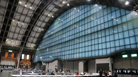 PA Media Votes are counted on long tables in the Manchester Central Convention and Conference Centre in the 2024 mayoral election.