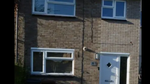 Hertfordshire Constabulary/CPS David Carrick's house is made of cream bricks and looks like an ordinary property in a residential street. It has a white door and windows with white panes.