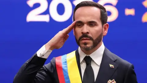 Abelardo de la Espriella salutes in a ceremonial sash