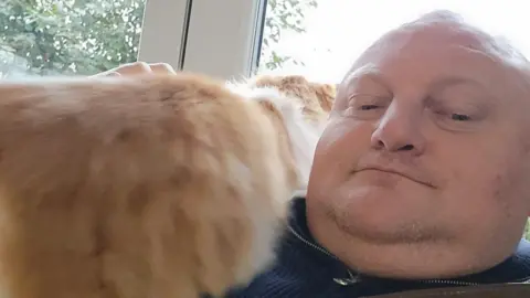 Mark King Mark King with a cat on his shoulder