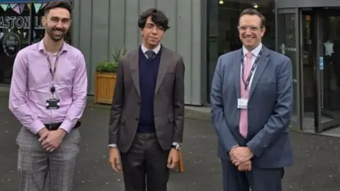 Aston University Frazer Roberts (north Africa regional manager), Mohamed Amine Mokrane and Matt Dean standing out The Adrian Cadbury Building at Aston University