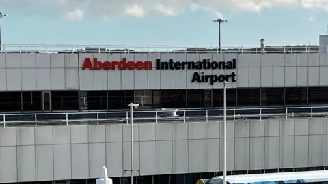 The Aberdeen International Airport sign at the front of the building