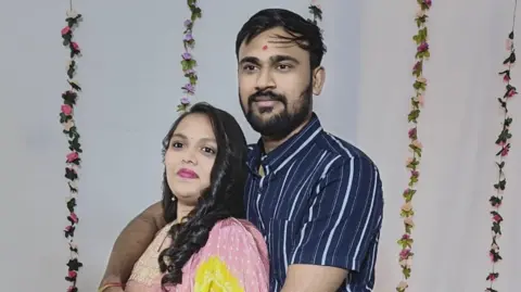 Hardik Avaiya with Vibhooti Patel looking at the camera
