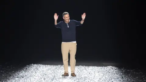 Andre Pain, EPA Belgian fashion Designer Dries Van Noten greets the audience at the end of the presentation of his Spring/Summer 2025 Menswear Collection during Paris Fashion Week