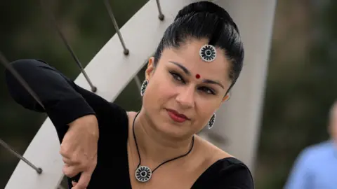 Desiree Bas Desiree Bas, standing on a bridge, dancing