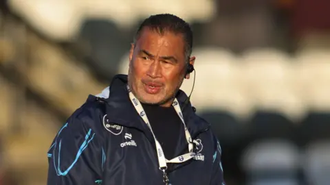 Pat Lam with his tracksuit on, out on the Kingston Park in the early evening sunshine during the warm-up ahead of the game 
