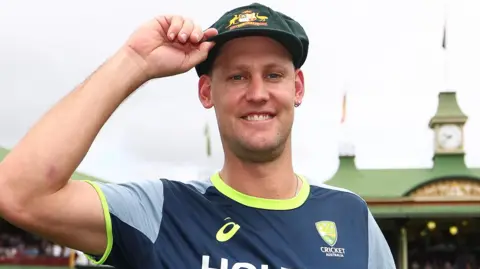 Australia cricketer Beau Webster touches the brim of his baggy green cap