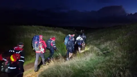 Glossop Mountain Rescue Team Rescuers carrying a casualty off the Peaks