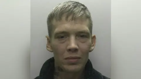 A mugshot of Danny Venning, who has short white hair and a black jacket.