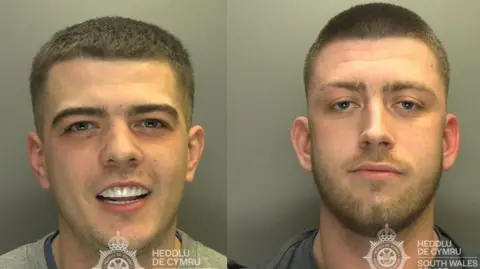 A composite showing two custody shots of Davies and Howell. On the left, Davies smiles looking at the camera. His white teeth are on show. On the right, Howell has a stern expression. He has short brown hair and a trimmed beard. 