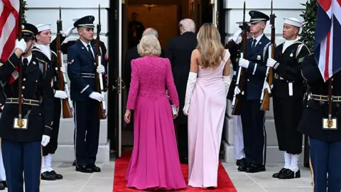 Getty Images Queen Camilla, King Charles III, U.S. President Donald Trump and First Lady Melania Trump enter The White House during an official state dinner hosted by the President and First Lady on day two of the State Visit of King Charles III and Queen Camilla to the United States of America, on April 28, 2026 in Washington, DC. 