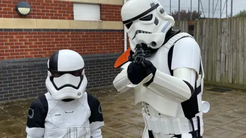 Family handout Nunu and James dressed as Stormtroopers