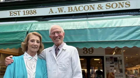 John and his wife Denise outside the shop