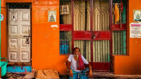 Zoya Mateen/BBC A man sits outside his home in Jai Hind camp in Delhi. 