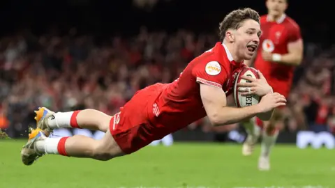 Dan Edwards dives over for a Wales try against Italy