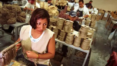 Getty Images Workers at a factory in Mexico that makes home furniture