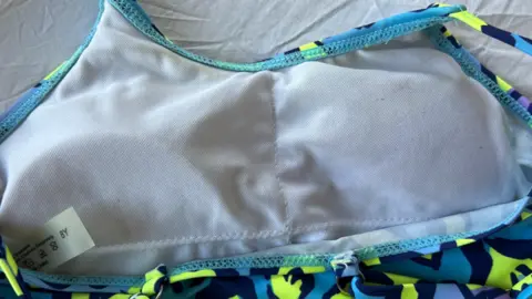 Kayleigh Shore A close-up of the swimsuit with the padding under a white mesh layer.