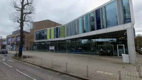 Google A large council building under grey skies.