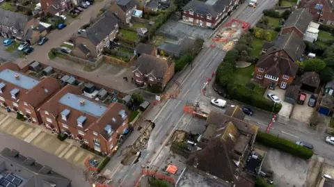 PA Media An aerial scene in Godstone after two sinkhole appeared in the small village