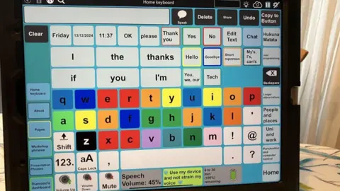 BBC/Joanita Musisi A computer screen displaying several words, phrases and letters.