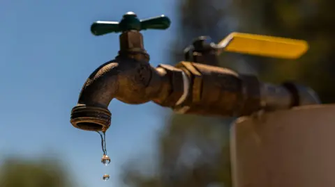 A dripping tap on a sunny day. 
