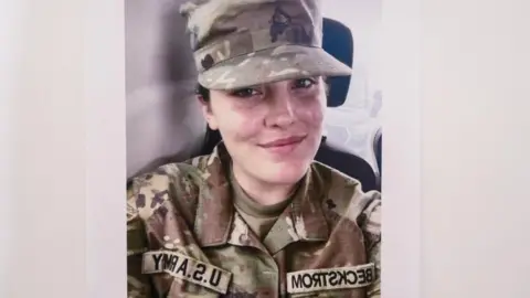 Reuters Sarah Beckstrom smiles in a selfie. She is wearing a camouflaged National Guard uniform. 