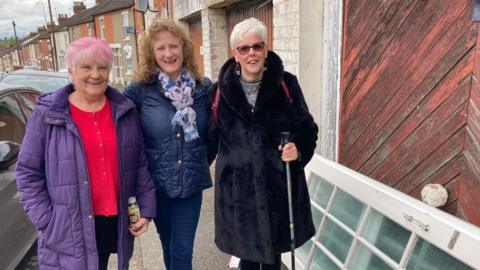 Ann Stevens, Janie Frost and Sharon Wood stood in a street