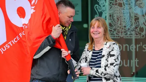 Getty Images Margaret Aspinall smiling with a fellow campaigner outside the coroner's court in 2016 