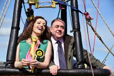 Getty Images Tasmina Ahmed-Sheikh and Alex Salmond pose for a photo while in a hot air balloon