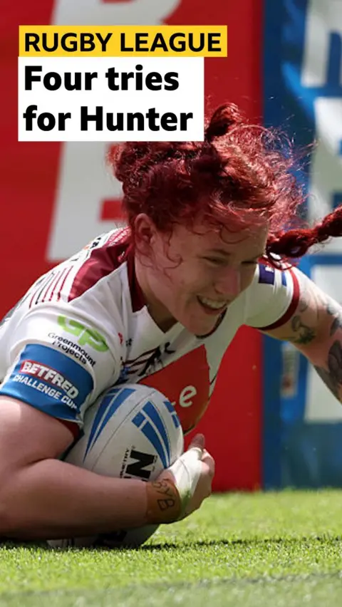 Eva Hunter of Wigan Warriors smiles as she touches down for a try 