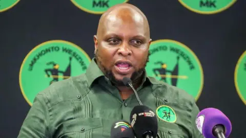Floyd Shivambu from South Africa's MK Party is seen addressing the media in a green shirt bearing his party's logo