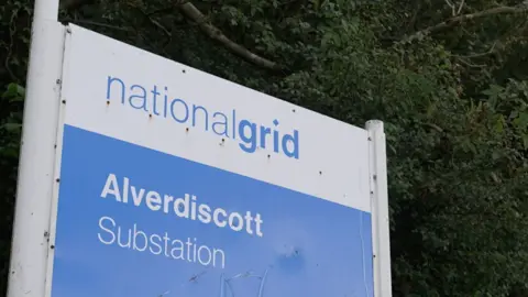 An image of a National Grid sign that reads Alverdiscott Substation. The signage is blue and white. 