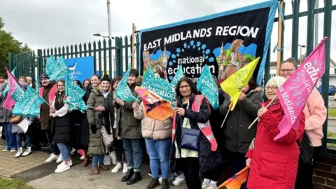 BBC Sir Francis Hill Community Primary School staff on a picket line holding placards